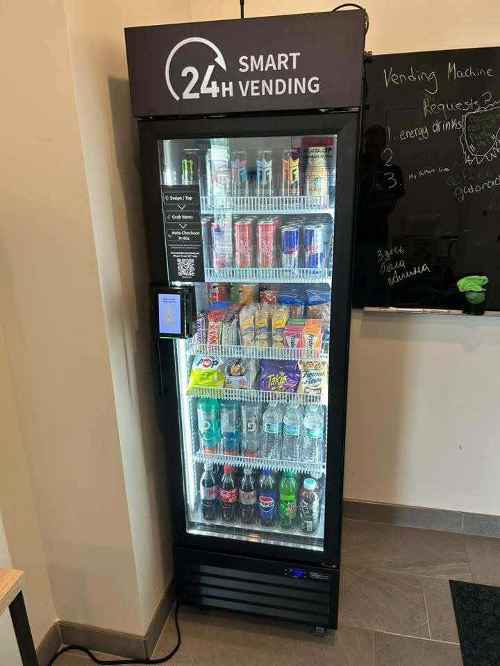 An NPC Snacks cooler beside a chalkboard listing residents' snack requests